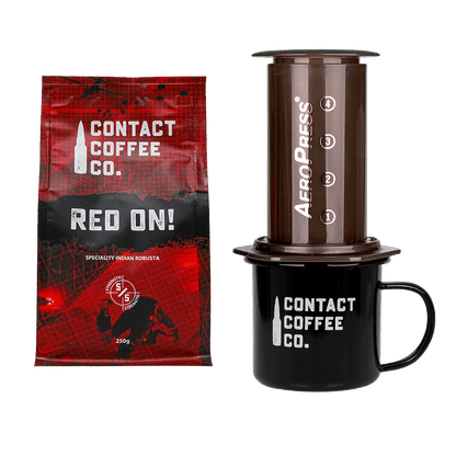 Contact Coffee Co. package, AeroPress coffee maker, and black mug on a white background