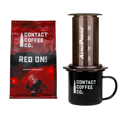 Contact Coffee Co. package, AeroPress coffee maker, and black mug on a white background