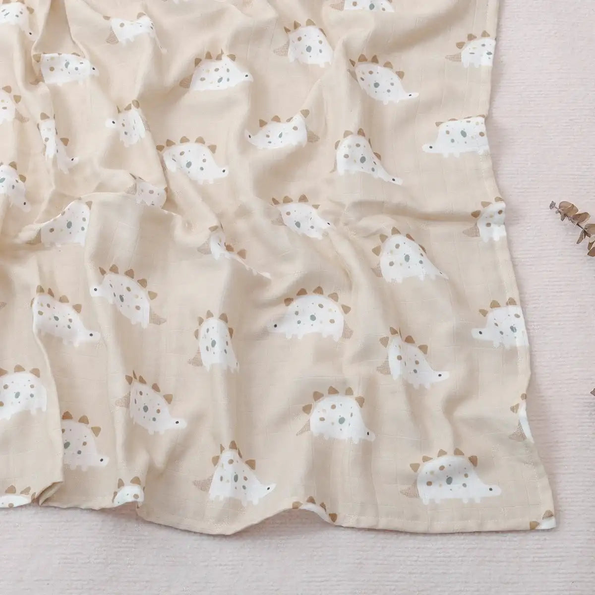 Beige fabric with dinosaur pattern on a light background