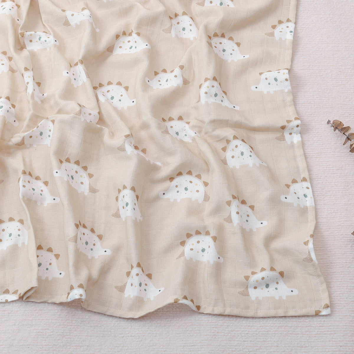 Beige fabric with dinosaur pattern on a light background
