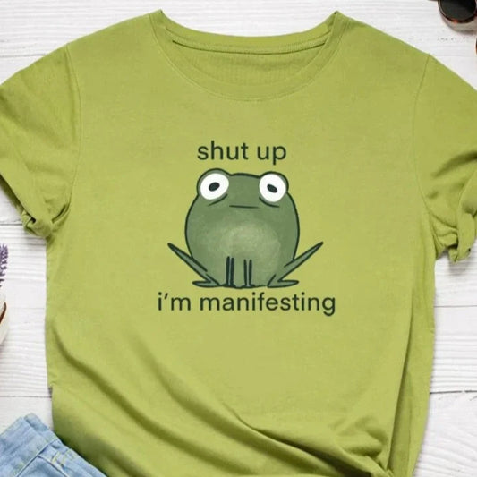 I'm Manifesting Frog Print Graphic T Shirt - T Shirts from Dear Cece - Just £14.99! Shop now at Dear Cece
