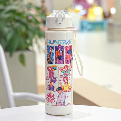 White water bottle with colorful graphics and text on a blurred indoor background