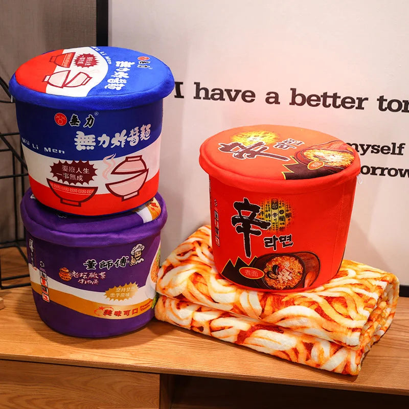 Three instant noodle containers with colorful lids on a wooden surface.