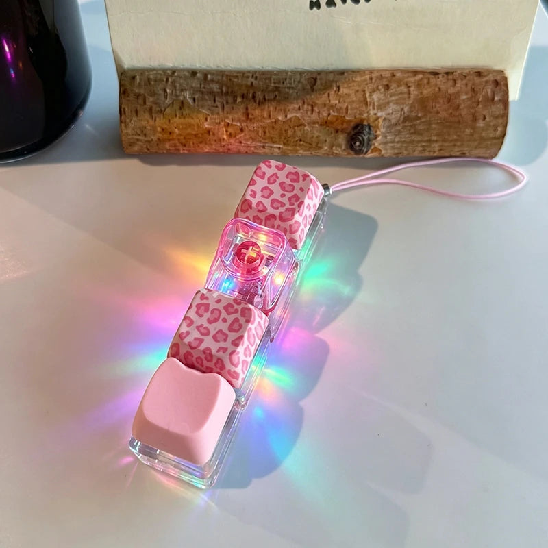 Pink and clear phone case with leopard print accents on a light surface