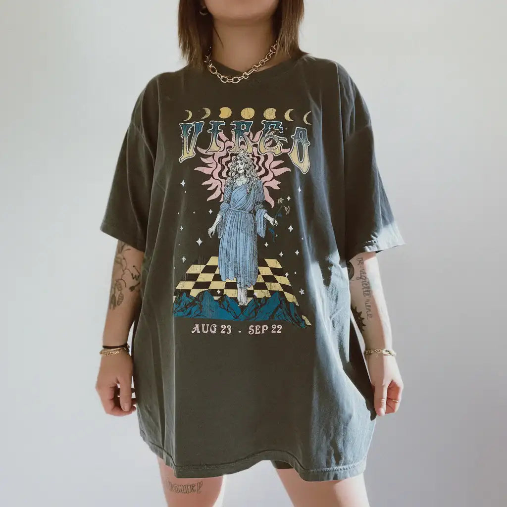 Person wearing a graphic t-shirt with a celestial design and text on a plain background