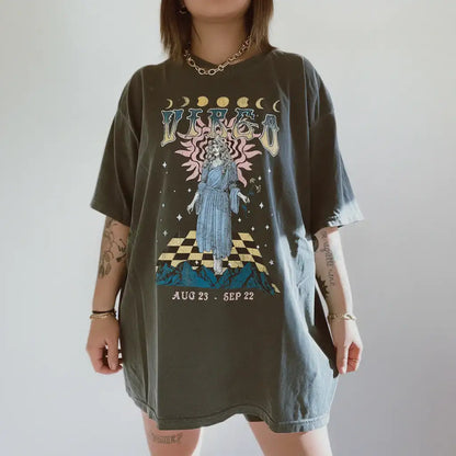 Person wearing a graphic t-shirt with a celestial design and text on a plain background