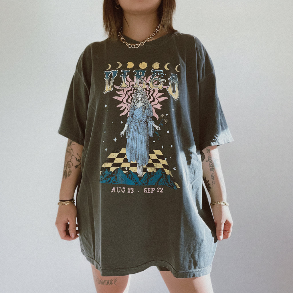 Person wearing a graphic t-shirt with a celestial design and text on a plain background