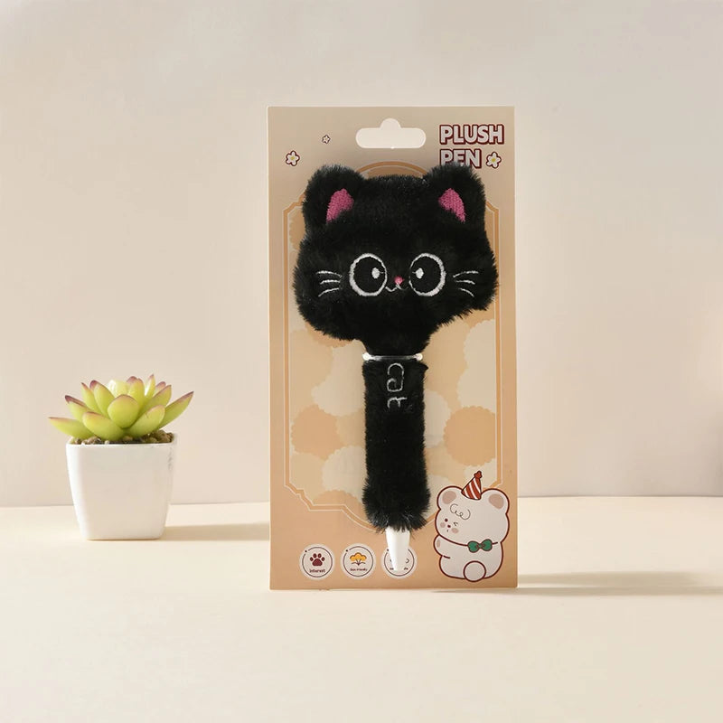 Plush black cat toy with pink ears in packaging on a light background