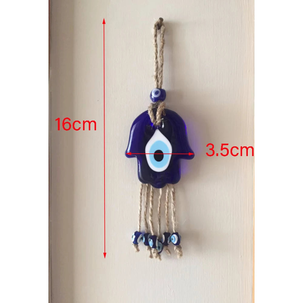 Decorative evil eye charm with measurements on a plain background