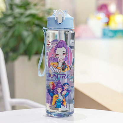 Clear water bottle with colorful character design on a table