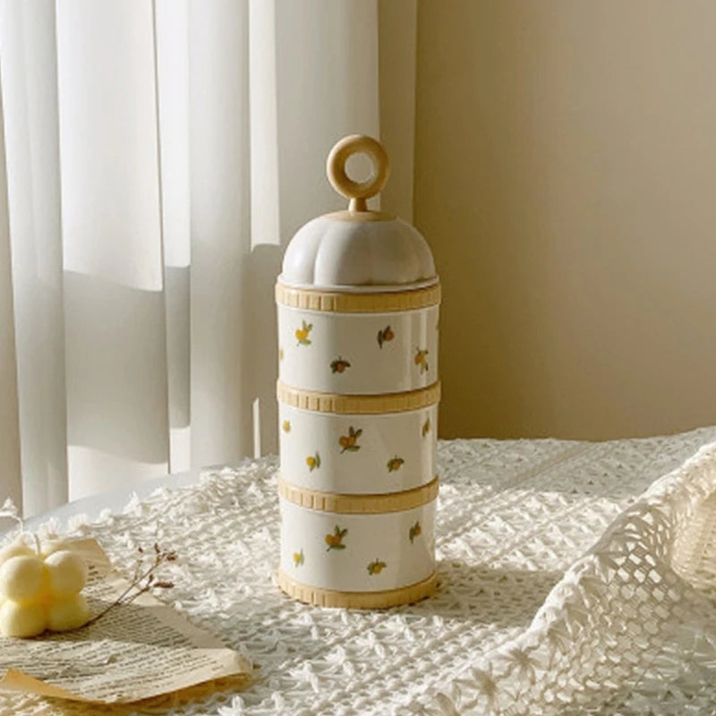 Decorative Baby Formula Dispenser Storage Container with gold accents on a textured surface with curtains in the background