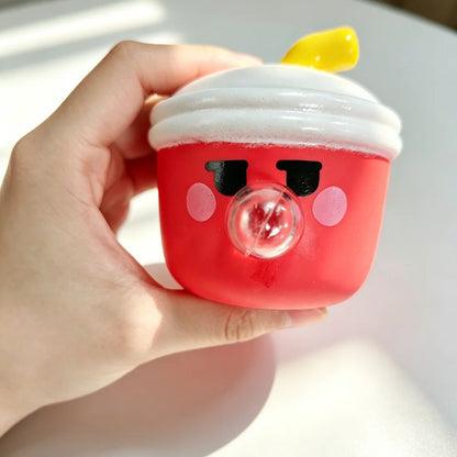 Hand holding a red cup with a white lid and yellow straw against a light background