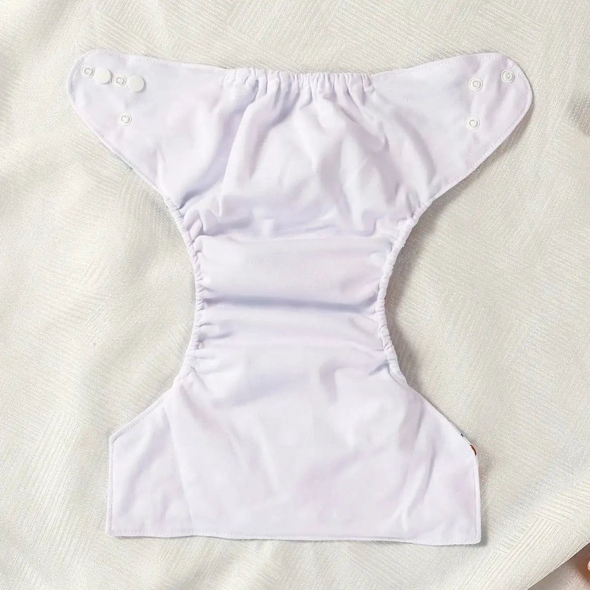 White diaper on a textured beige surface