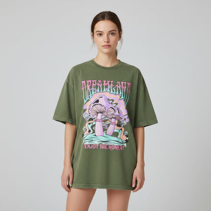 Green t-shirt with mushroom graphic and 'Dreamland Enjoy the Moment' text on a white background