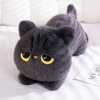 Gray cat-shaped plush toy on a white surface