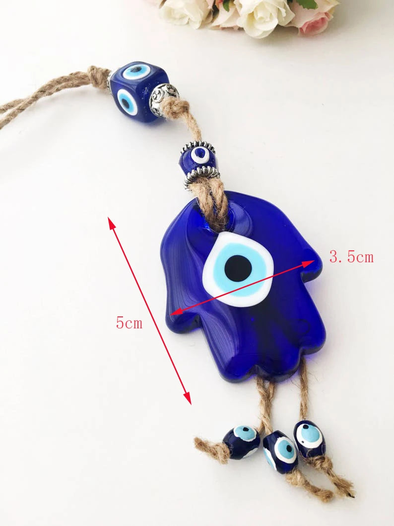 Blue evil eye charm with measurements on a white background