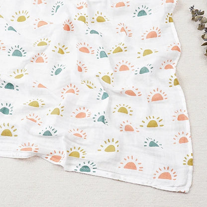 White fabric with colorful sun pattern on a light wooden surface