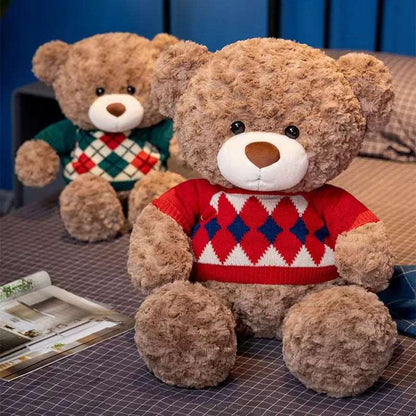 teddy bears sitting on a bed