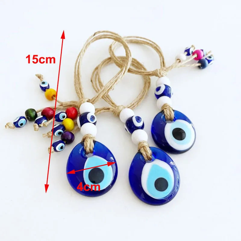 Blue evil eye charms with measurement details on a white background