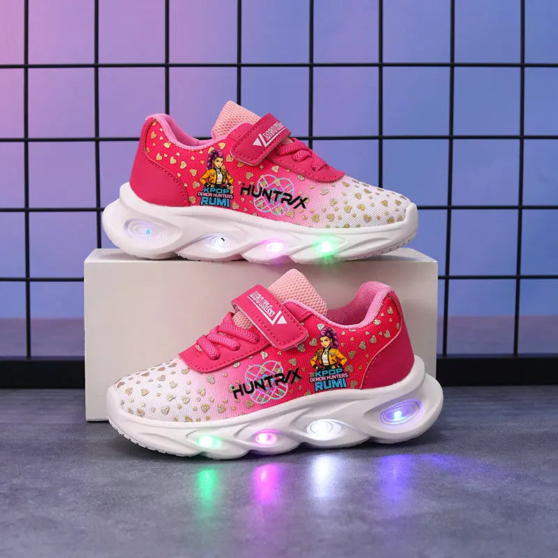Pink children's sneakers with LED lights on a gray surface and tiled wall background