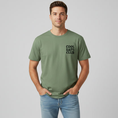Man wearing green cool dads club tshirt