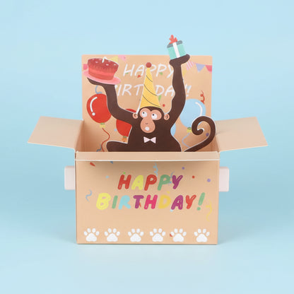 Open birthday card with a monkey illustration and 'Happy Birthday!' text on a white background
