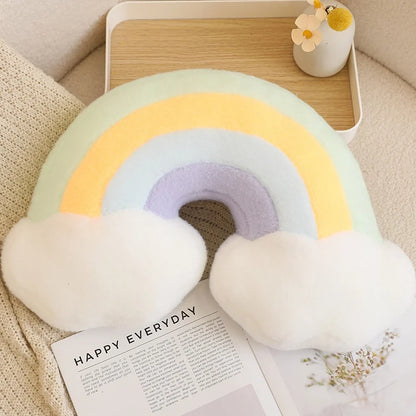 Rainbow-shaped pillow on a surface with a magazine underneath