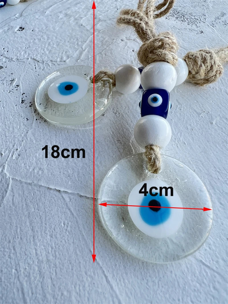 Decorative evil eye charm with measurements on a textured surface