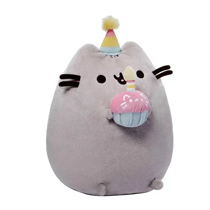 Plush toy resembling a cat with party hat and cupcake decoration on a white background