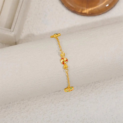 Gold bracelet with a decorative clasp on a white surface