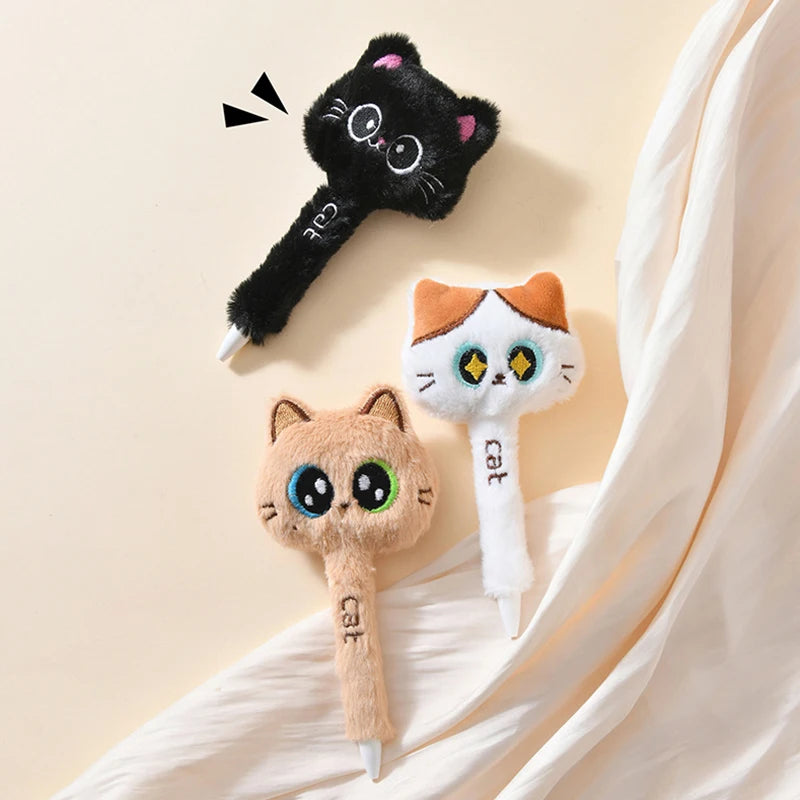 Three cat-shaped phone holders on a beige fabric background