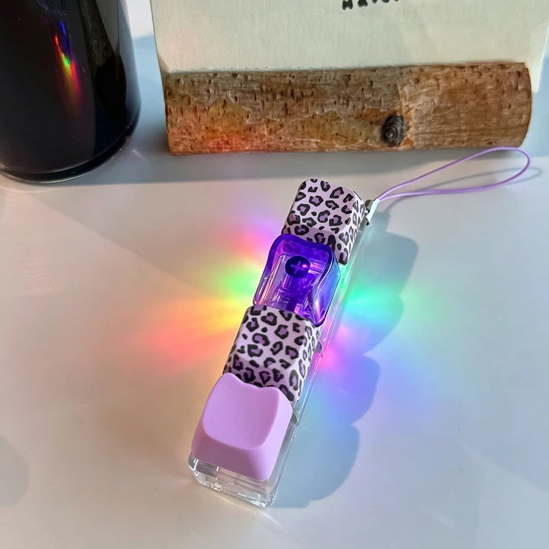 Small electronic device with colorful light effects on a white surface