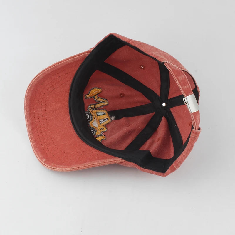 Red cap with black strap and logo on a light gray background