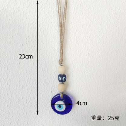 Evil eye pendant and measurement details on a white background