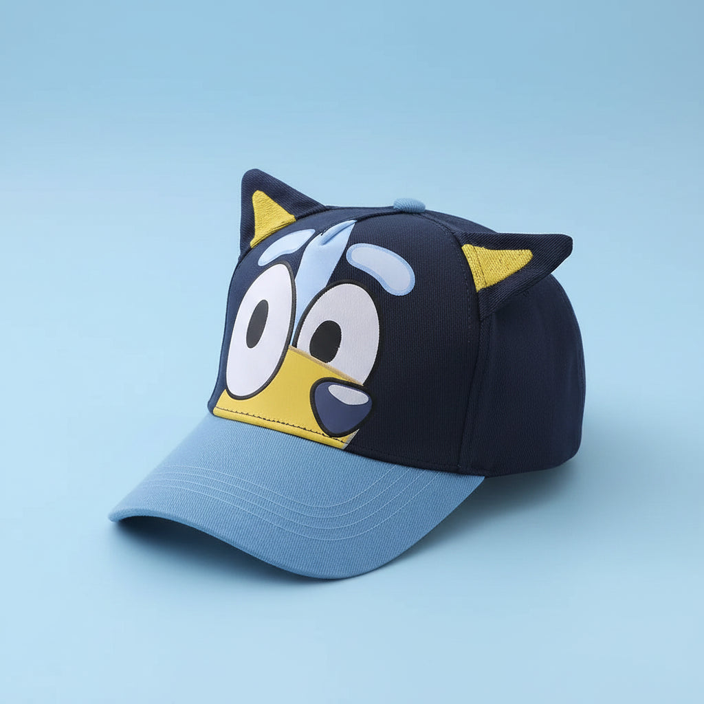 Blue and black cap with cartoon face design on a white surface
