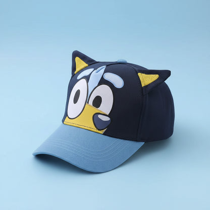 Blue and black cap with cartoon face design on a white surface