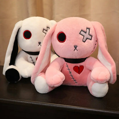 white and pink plush toys side by side