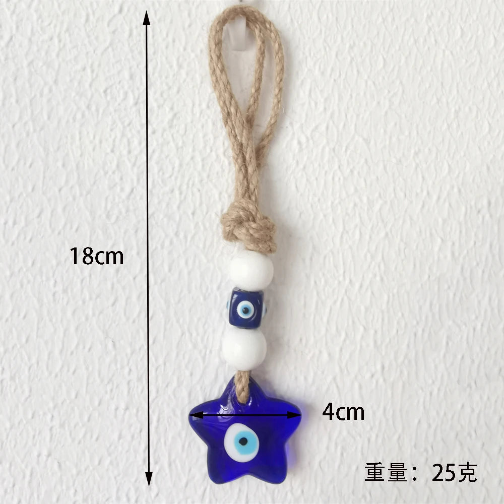 Star-shaped blue evil eye charm with a white bead on a rope against a white background