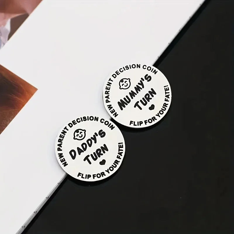 Two round decision coins with text on a black surface