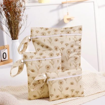 Beige patterned bags with white zippers on a light surface