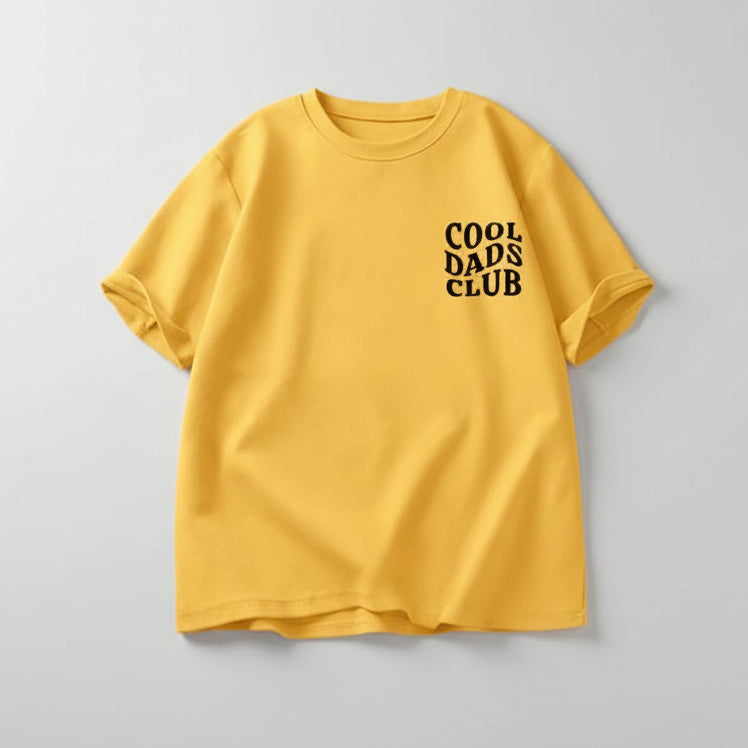 Man wearing yellow cool dads club tshirt