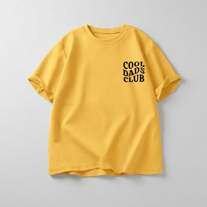 Man wearing yellow cool dads club tshirt