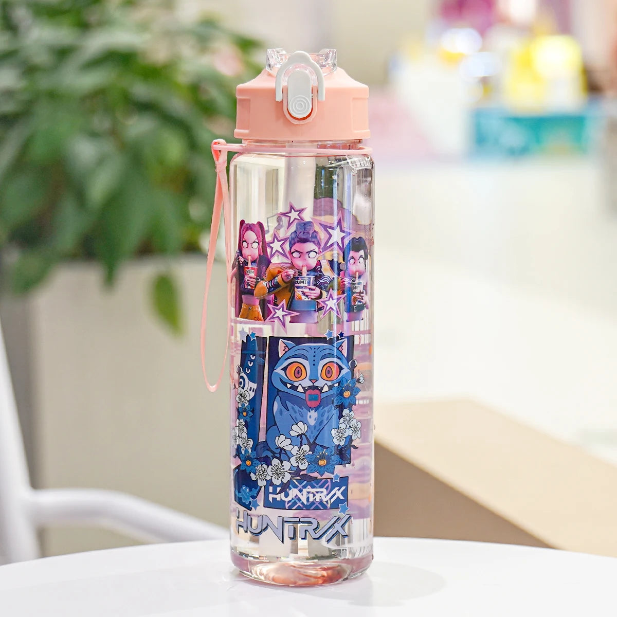 Cartoon-themed water bottle on a table with a blurred background
