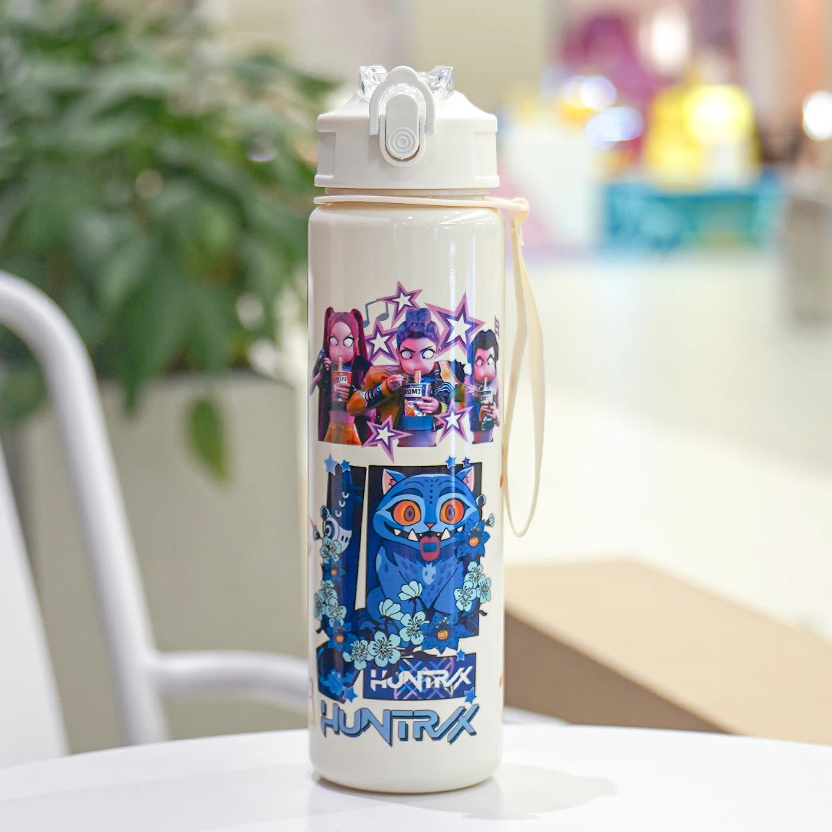 Water bottle with colorful character design on a table