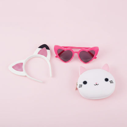 Cat-themed hairband, sunglasses, and coin purse on a pink background