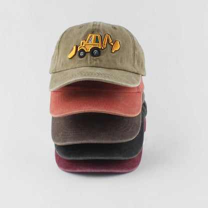 Stack of three baseball caps with a construction vehicle logo on a light gray background