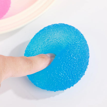 Blue textured ball held by a finger on a white background