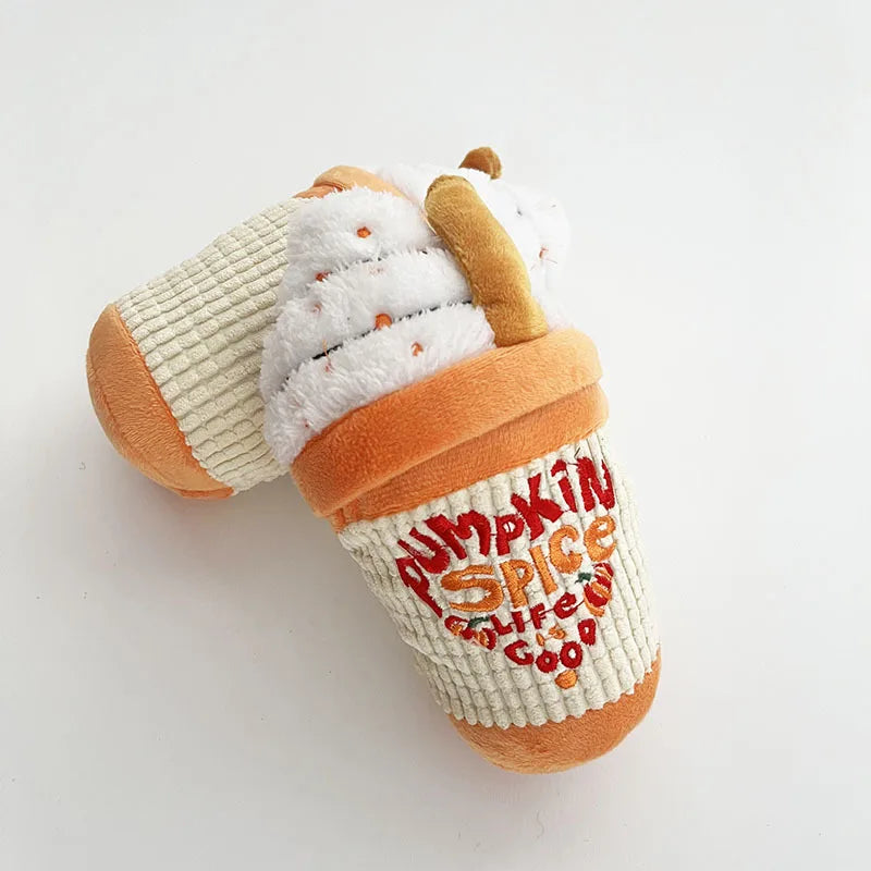 Toy resembling a cup with whipped cream and a straw on a white background