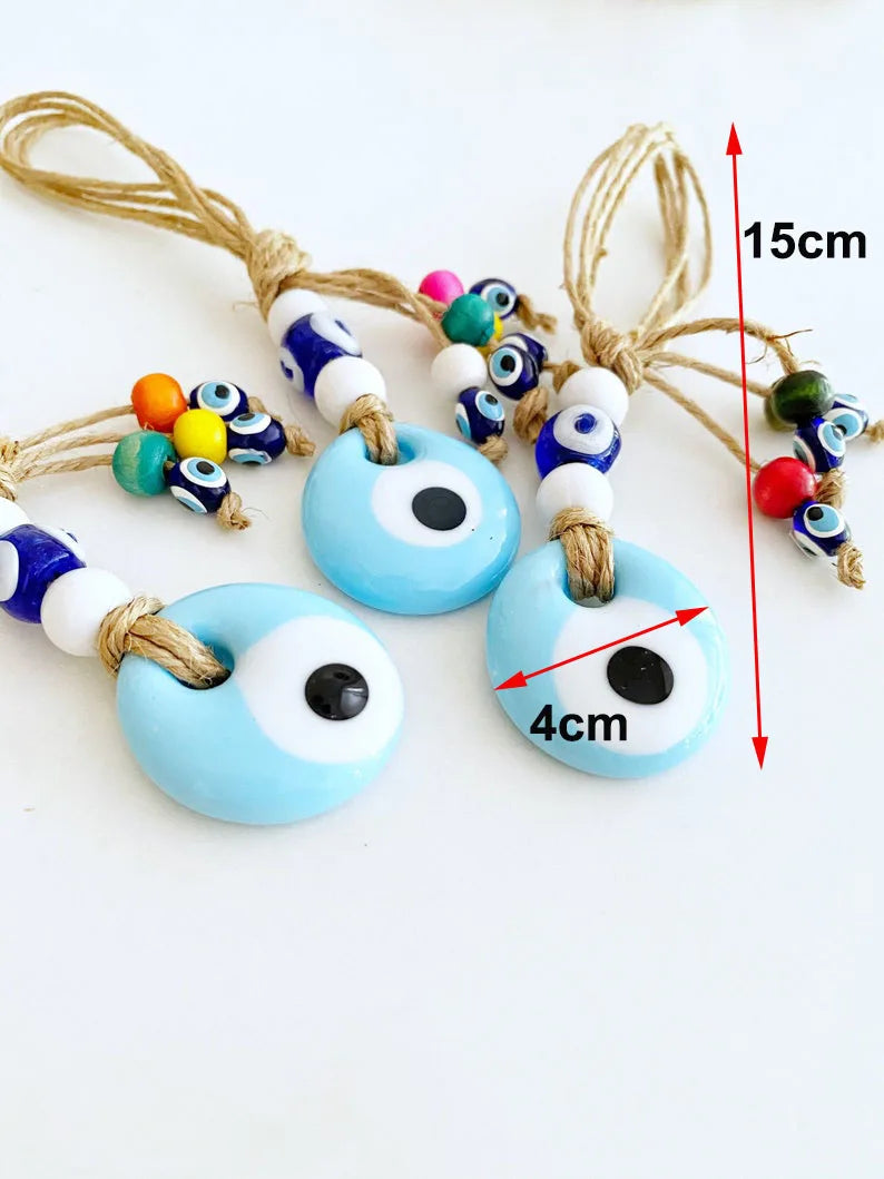 Set of blue evil eye charms with colorful beads on a white background