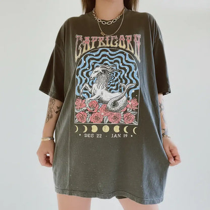 Person wearing a t-shirt with Capricorn zodiac design on a plain background